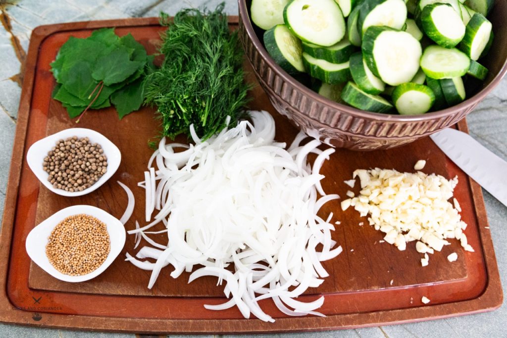 Cucumber Pickle ingredients on a wooden cutting board