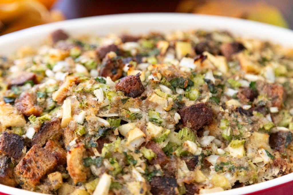 close up of gluten free stuffing with sausage, apples, herbs, and croutons