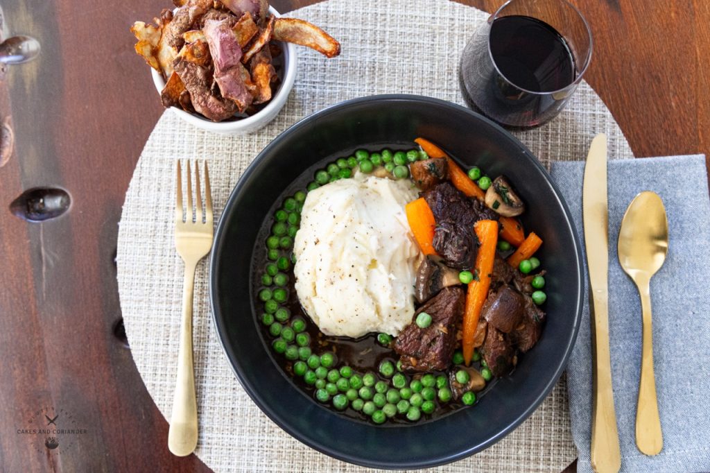 Ultimate Beef Pot Roast Plated with mashed potatoes, and red wine
