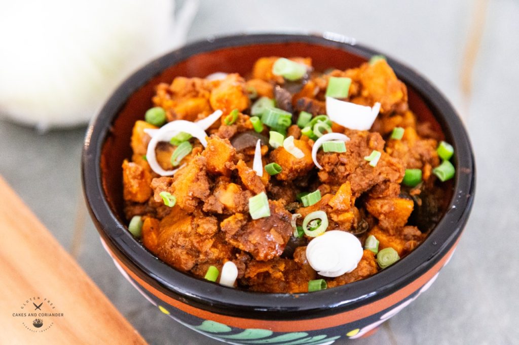 Sweet Potato Chorizo Taco Filling in a glazed terracotta Mexican bowl. This can be used for vegetarian tacos