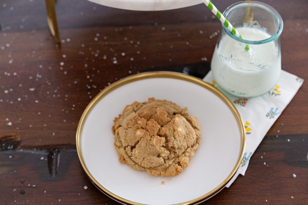 Cookie on a white plate with glass of milk