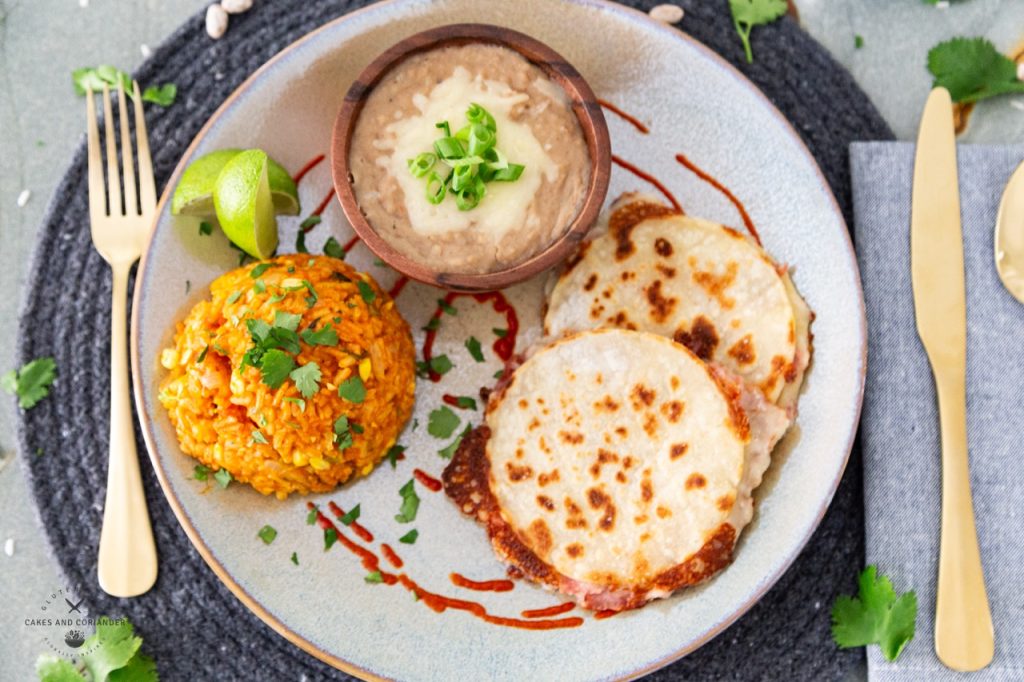 Refried beans and Mexican Rice plated with corn tortilla quesadillas